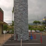 rock climbing wall set up in parking lot